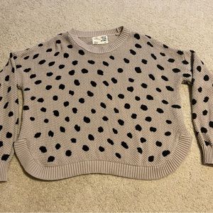 Crop polka dotted sweater with cute detail on sides.